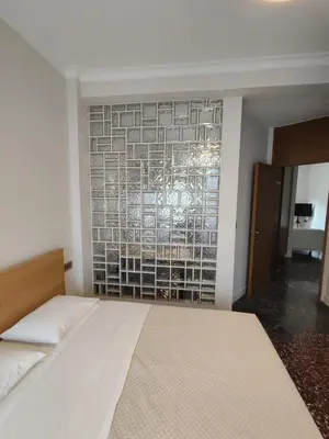 a bedroom with a bed and a brick wall at Apartment Near Beach & Old Port in Chania Town