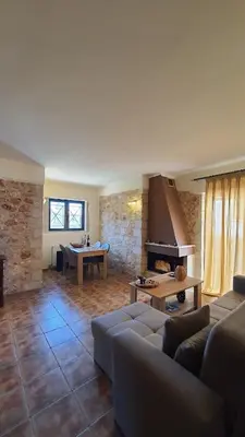 a living room with a couch and a table at Despoinas House in Kounoupidhianá