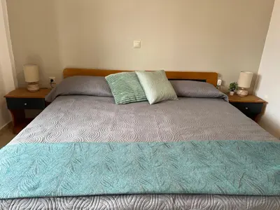 a bed with two pillows on it in a bedroom at Azure Sea Bliss at The Erodios Apartments in Kalyves