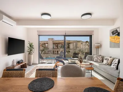 a living room with a couch and a tv at Iris Luxury Apartment in Chania Town