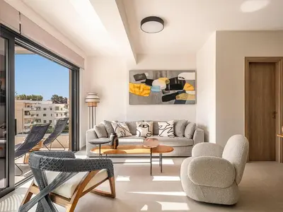 a living room with a couch and a table and chairs at Iris Luxury Apartment in Chania Town