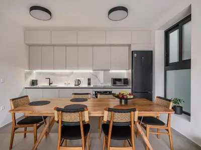 a kitchen with a large wooden table and chairs at Iris Luxury Apartment in Chania Town