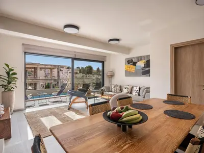 a living room with a table with a bowl of fruit on it at Iris Luxury Apartment in Chania Town