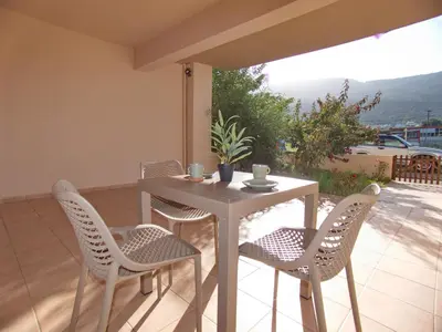 a white table and chairs on a patio at Peris #2 - Souda in Souda