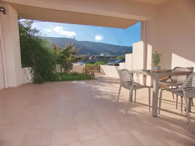a patio with a table and chairs and a view at Peris #2 - Souda in Souda