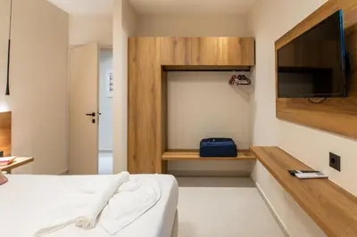a bedroom with a bed and a flat screen tv at Mystrali II in Galatás