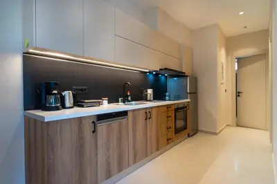 a kitchen with wooden cabinets and a counter top at Mystrali II in Galatás