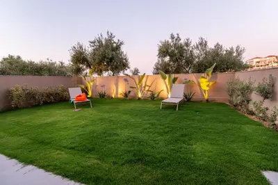 a yard with two chairs and a fence at Mystrali II in Galatás