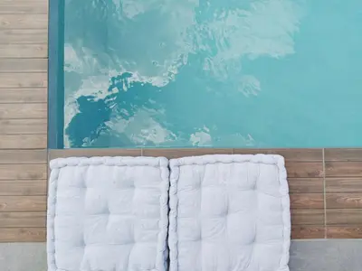 two white beds in a room with a painting at Villa Naiades Traditional Cretan Stone House with private Pool and Garden in Chania in Arménoi