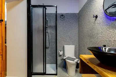 a bathroom with a shower and a sink at Sea & City - Luxury Maisonette Steps from the Beach with Private Terrace in Chania Town