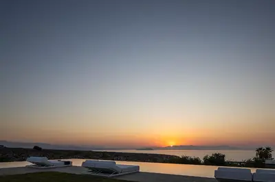 a sunset view from a villa with a swimming pool at Orus Villa in Chania Town