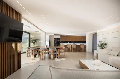 an open living room and kitchen with a table and chairs at Orus Villa in Chania Town