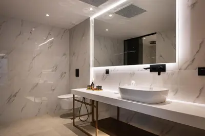 a bathroom with a sink and a toilet and a mirror at Orus Villa in Chania Town