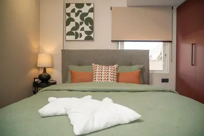 a bed with a stuffed animal laying on top of it at Panterra-Chania Center in Chania Town
