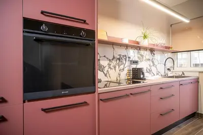 a kitchen with red cabinets and a stove top oven at Panterra-Chania Center in Chania Town