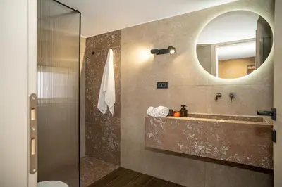 a bathroom with a sink and a mirror at Panterra-Chania Center in Chania Town