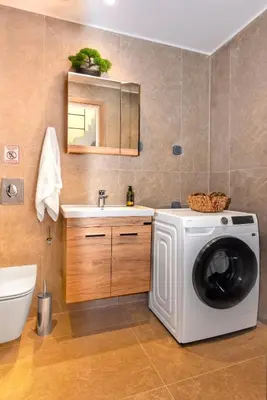 a bathroom with a washing machine and a sink at Lavender Loft in Chania Town