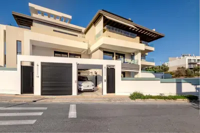 a house with a car parked in the driveway at Lavender Loft in Chania Town