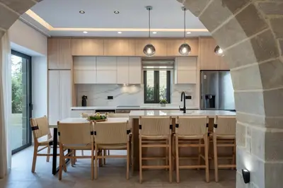 an open kitchen with a dining table and chairs at Golden Silence in Plataniás