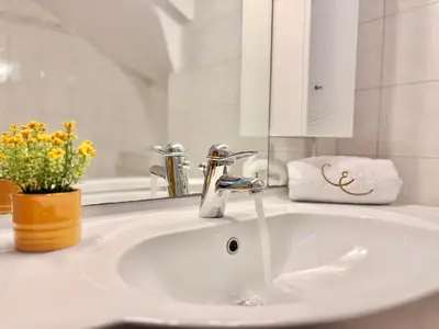 a bathroom sink with a faucet and a mirror at Casa Eygenia in Galatás