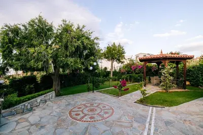 a garden with a gazebo and a patio at Casa Eygenia in Galatás