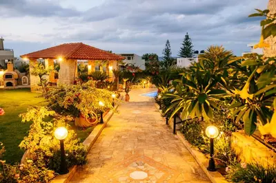 a walkway in a garden with lights and plants at Casa Eygenia in Galatás