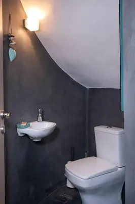 a bathroom with a white toilet and a sink at Holiday Home Villa vacanze Agave Creta con piscina privata by Interhome in Litsárdha