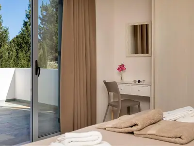 a bedroom with a bed and a desk and a window at Holiday Home Villa vacanze Agave Creta con piscina privata by Interhome in Litsárdha