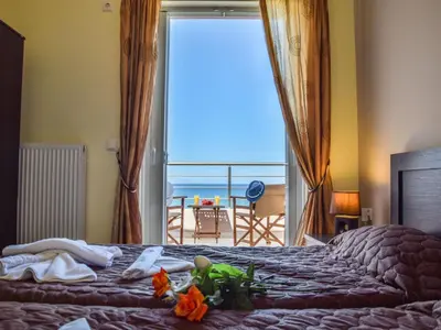 a bedroom with a bed with a view of the ocean at Apartment Charmante Ferienwohnung Rubini 2 by Interhome in Agia Marina Nea Kydonias