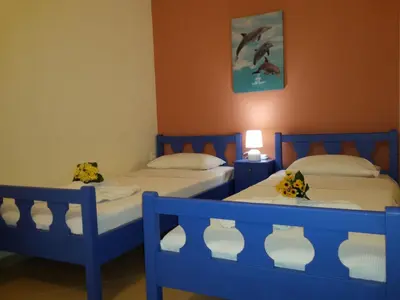 two blue beds in a room with a wall at Apartment Moderne Wohnung Rubini 3 by Interhome in Chania Town