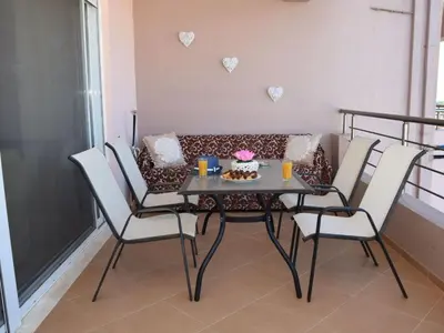 a table and chairs in a living room with a couch at Apartment Rubini 1 by Interhome in Agia Marina Nea Kydonias