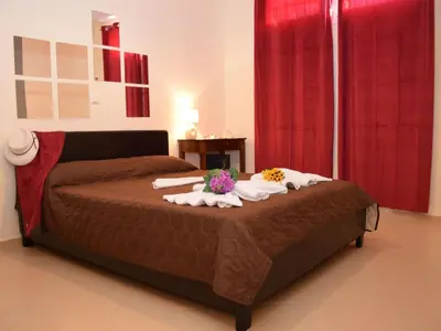 a bedroom with a bed with towels and flowers on it at Apartment Gemütliche Ferienwohnung Rubini 4 by Interhome in Agia Marina Nea Kydonias