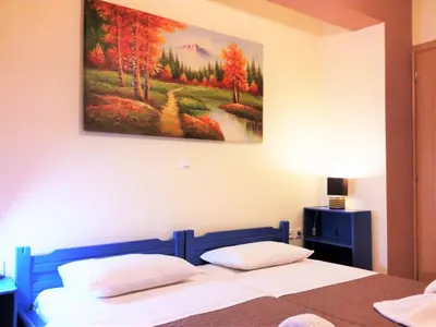 a bedroom with a bed with a painting on the wall at Apartment Gemütliche Ferienwohnung Rubini 4 by Interhome in Agia Marina Nea Kydonias