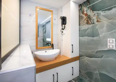 a bathroom with a white sink and a mirror at Chania Luxury City Retreat , Hammam & outdoor Jacuzzi in Chania Town