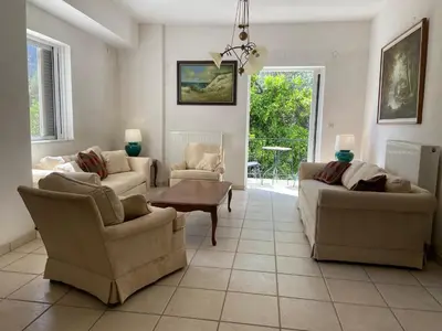a living room with two couches and a table at Ellie's Kantanos in Kántanos