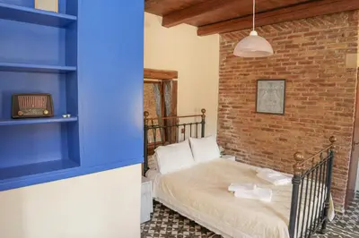 a room with a bed and a brick wall at Stone-Built Traditional Villa with Pool in Sfakia in Ímbros
