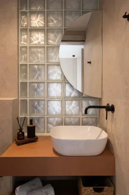 a bathroom with a sink and a mirror at Raviewha Luxury Apartments 3 in Ravdhoúkha