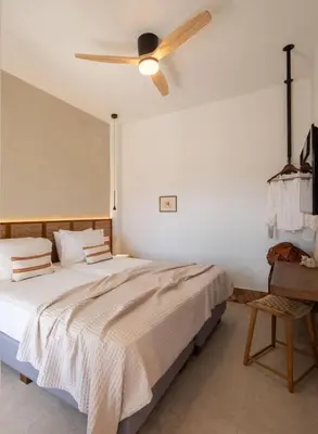 a bedroom with a bed with a ceiling fan at Raviewha Luxury Apartments 3 in Ravdhoúkha