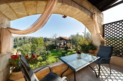 a patio with a table and chairs and a window at Villa Levedeli in Nerokhórion