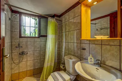 a bathroom with a sink and a toilet and a shower at Manoli's House in Douliana