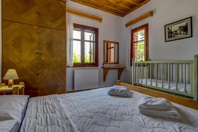 a bedroom with a bed with two towels on it at Manoli's House in Douliana