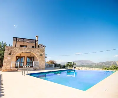 a villa with a swimming pool and mountains in the background at Villa Anna Gaia In Tzivaras in Tsivarás