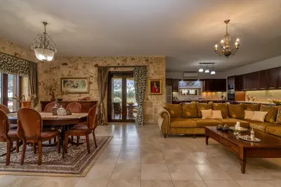 a living room with a table and a couch at Villa Chrysseva in Plátanos
