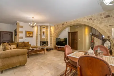 a living room with a couch and a table at Villa Chrysseva in Plátanos