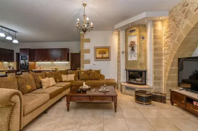 a living room with a couch and a fireplace at Villa Chrysseva in Plátanos