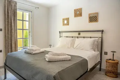 a bedroom with a bed with two towels on it at REN Apartment in Stalos