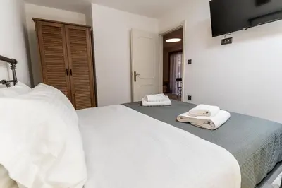 a bedroom with two white towels on a bed at REN Apartment in Stalos