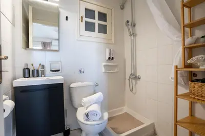 a bathroom with a toilet and a sink and a shower at REN Apartment in Stalos