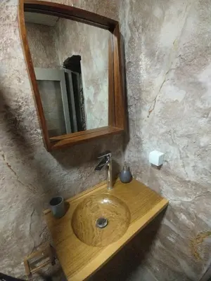 a bathroom with a wooden sink and a mirror at Meteoron Platanias in Plataniás