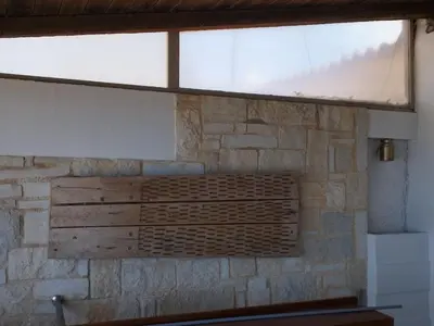 a window in a room with a stone wall at Meteoron Platanias in Plataniás